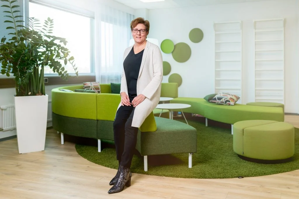 Heini Kuusela-Opas in front of green sofa