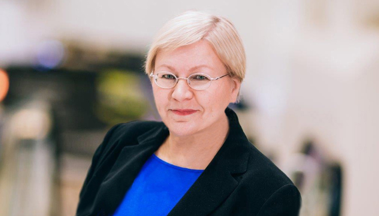 Tarja Gordienko smiling to the camera with blurred background